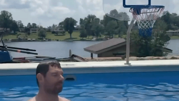 Eric Swalwell throws a basketball into a hoop while in his personal lakeside pool