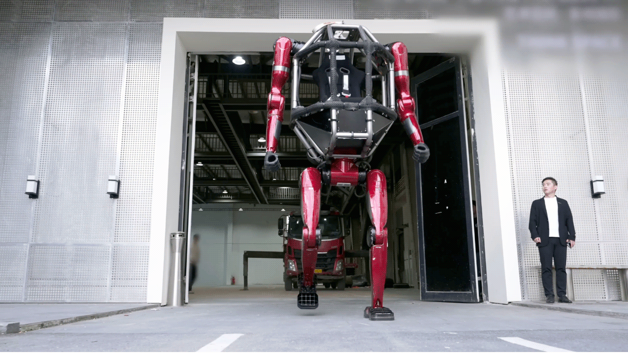 Unitree’s GD01 rideable robot is pictured towering over a person